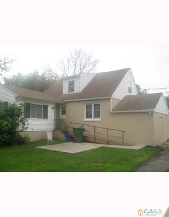 195 Plainfield Road Edison, NJ 08820 - Photo 2 of 4 a front view of a house with a yard and garage
