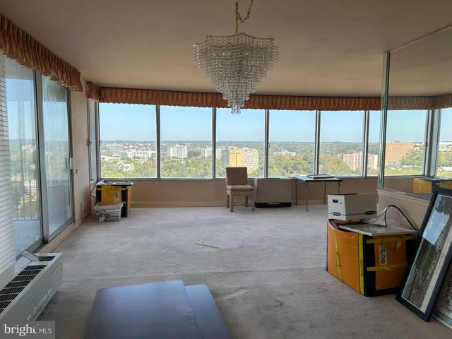 a living room with a bed furniture and a window