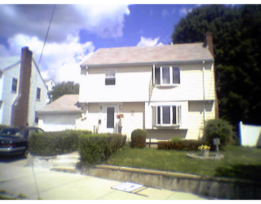47 Clancy Road Boston, MA 02124 - Photo 1 of 11 a view of a white house next to a yard with big trees