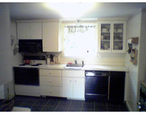 47 Clancy Road Boston, MA 02124 - Photo 4 of 11 a kitchen with a sink and a stove top oven