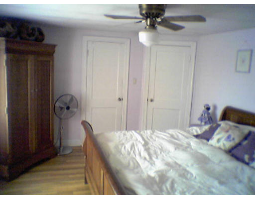 47 Clancy Road Boston, MA 02124 - Photo 6 of 11 a bedroom with a bed and a chandelier