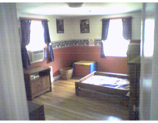 47 Clancy Road Boston, MA 02124 - Photo 7 of 11 a bedroom with a bed and a flat tv screen on dresser
