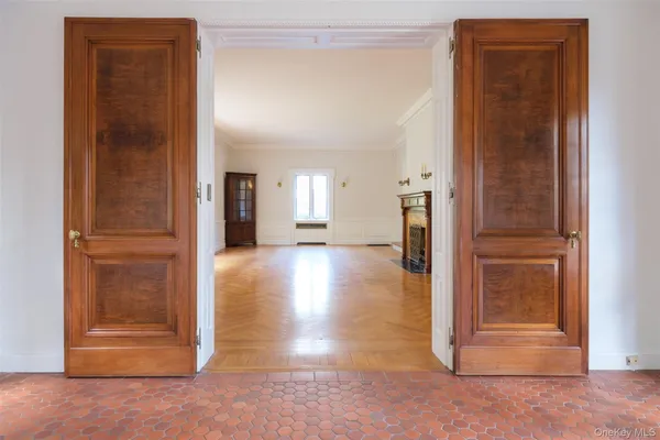a kitchen with stainless steel appliances a dining table chairs a sink dishwasher and cabinets with wooden floor