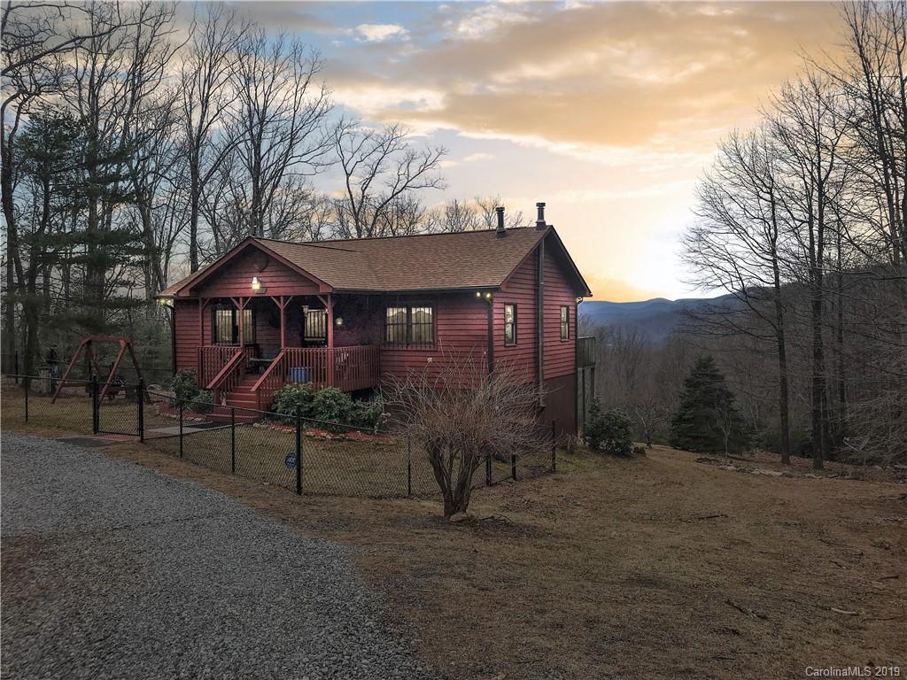 707 Phillips Gap Road Purlear, NC 28665 - Photo 1 of 27 a view of a house with a yard and sitting area