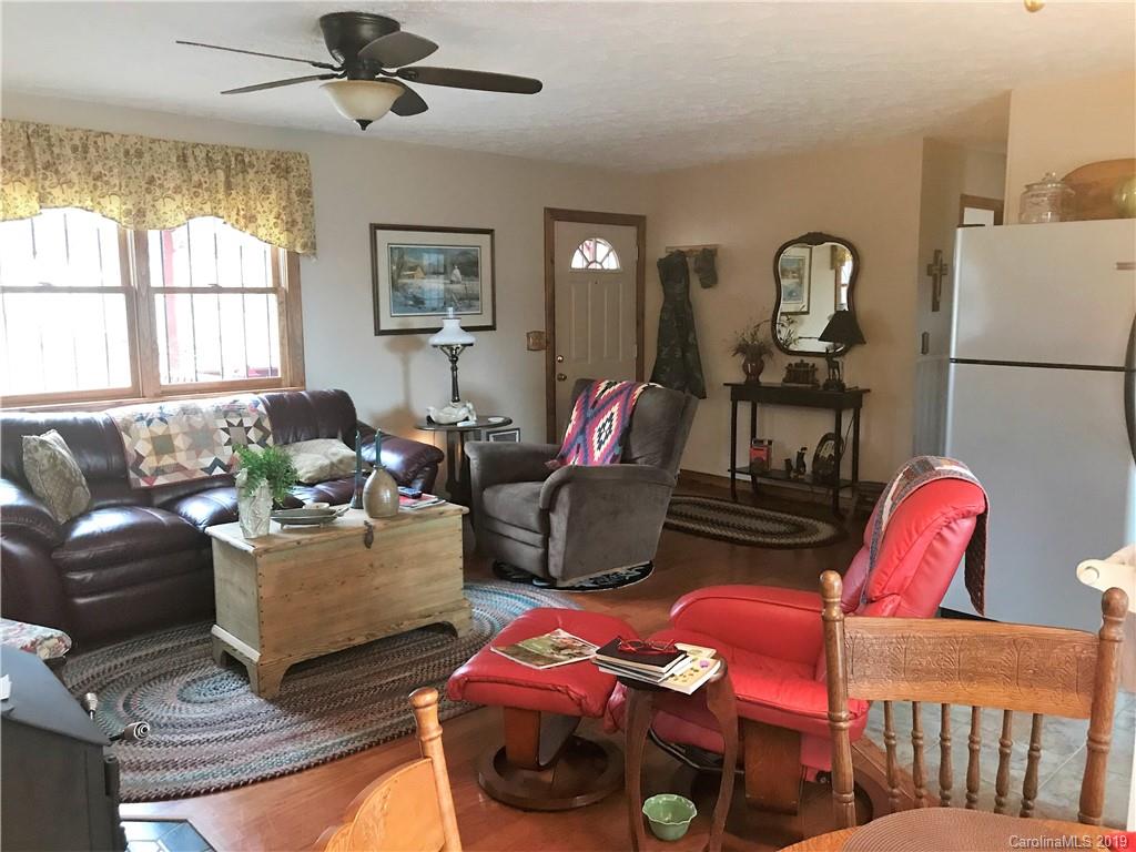 707 Phillips Gap Road Purlear, NC 28665 - Photo 11 of 27 a living room with furniture a flat screen tv and a window