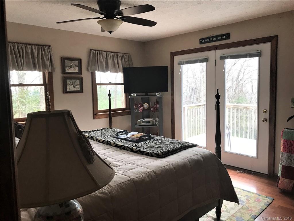 707 Phillips Gap Road Purlear, NC 28665 - Photo 15 of 27 a bedroom with a bed and a large window