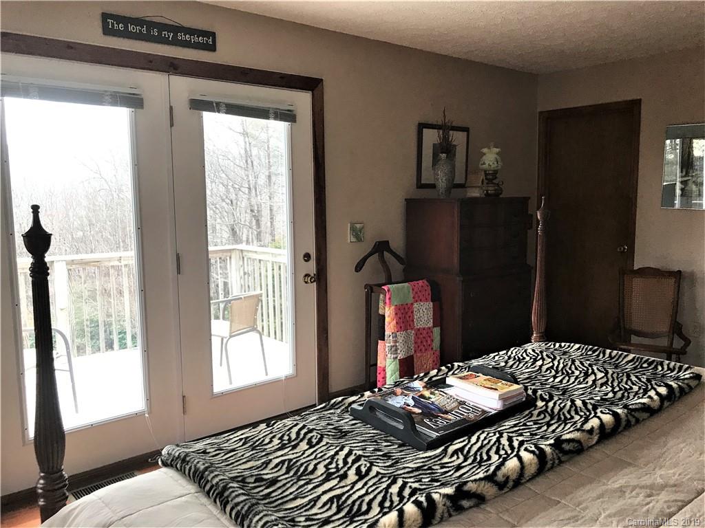 707 Phillips Gap Road Purlear, NC 28665 - Photo 16 of 27 a bedroom with a bed and wooden floor
