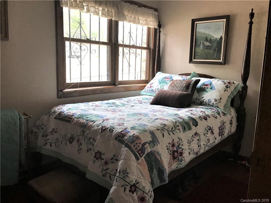 707 Phillips Gap Road Purlear, NC 28665 - Photo 17 of 27 a large bed sitting in a bedroom next to a window