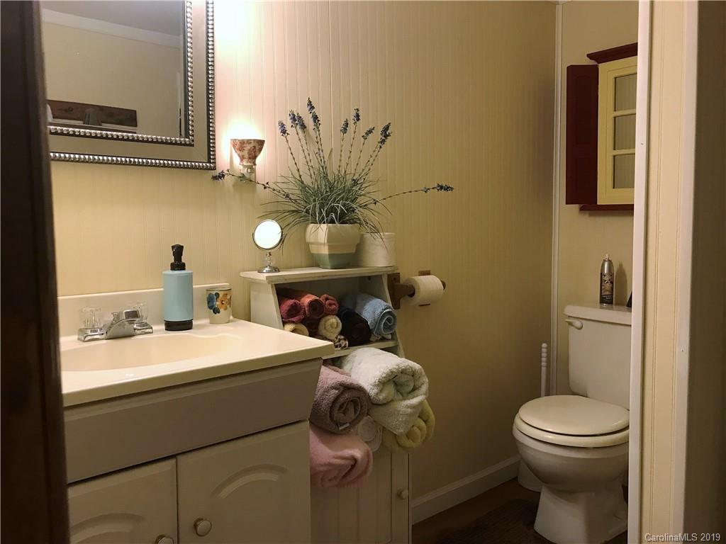 707 Phillips Gap Road Purlear, NC 28665 - Photo 22 of 27 a bathroom with a sink toilet and mirror
