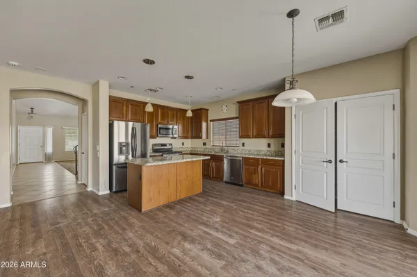 wooden floor fireplace and windows in an empty room