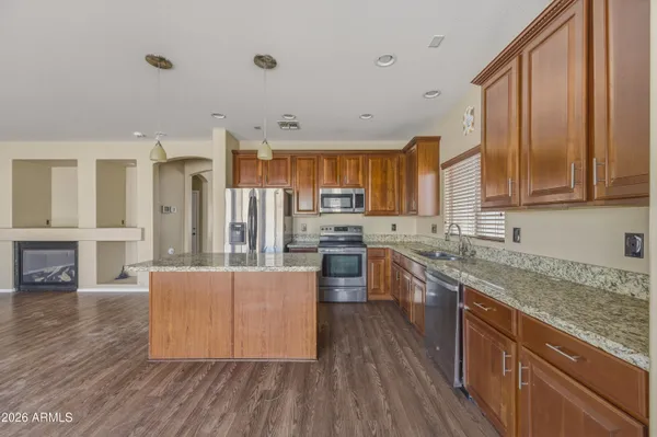 a view of empty room with wooden floor and fireplace