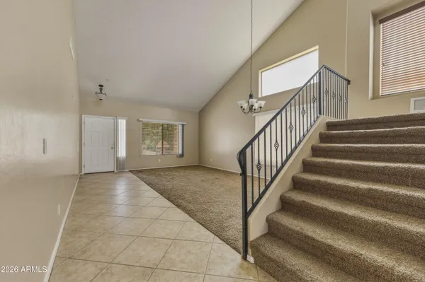 a kitchen with stainless steel appliances granite countertop wooden cabinets a refrigerator a sink a stove a refrigerator and cabinets