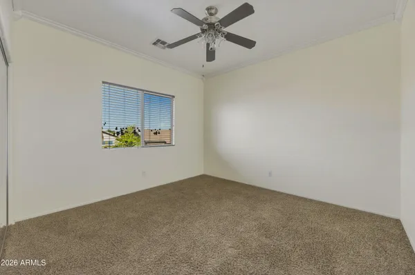 an empty room with closet and windows