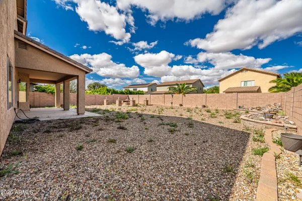 a view of a backyard with sitting area