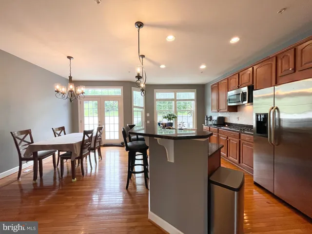 a kitchen with counter top space cabinets and wooden floor