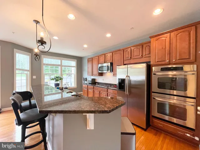 a kitchen with granite countertop a stove and refrigerator
