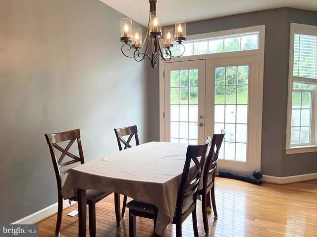 a view of a dining room with furniture wooden floor and chandelier
