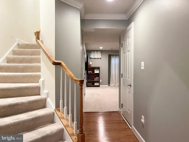 a view of entryway and hall with wooden floor