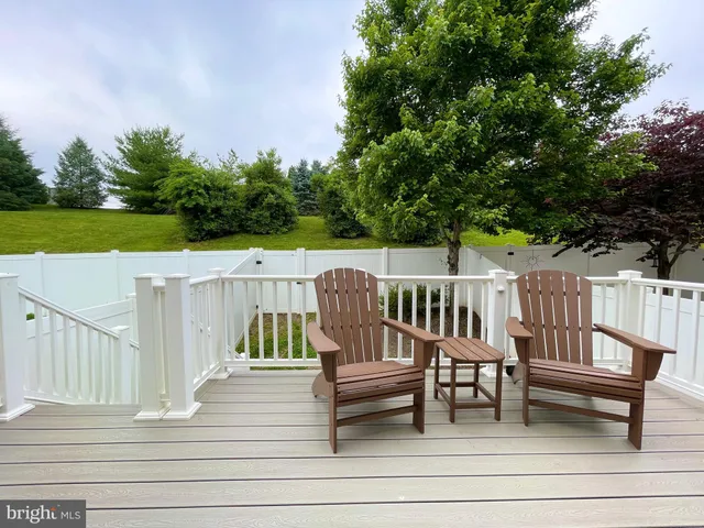 a view of a terrace with seating area and trees