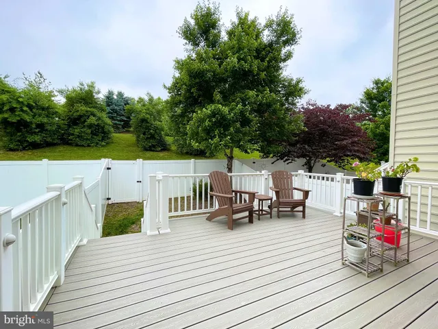 a view of deck with furniture and garden
