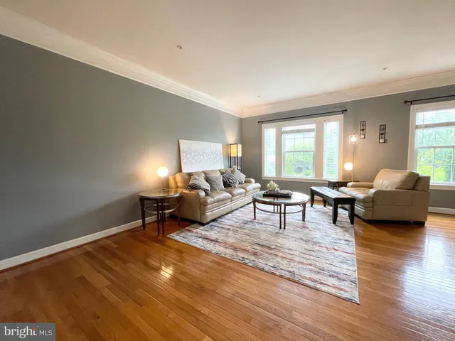 a living room with furniture and a lamp