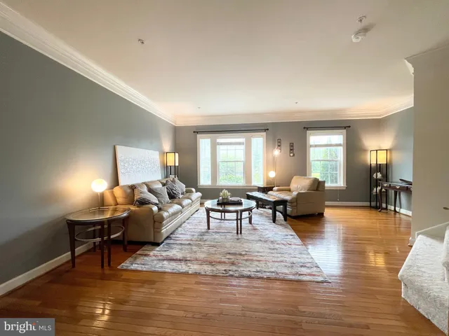 a living room with furniture window and wooden floor