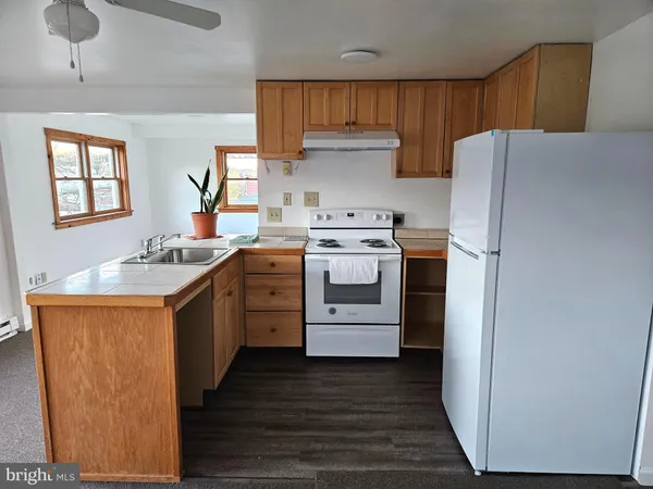 a kitchen with a stove a sink and a refrigerator