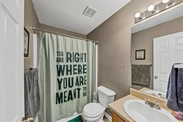 a spacious bedroom with a bed and a couch