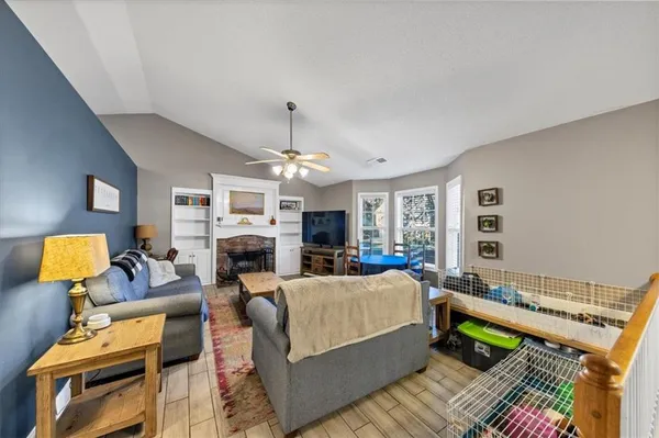 a living room with furniture a rug and a chandelier