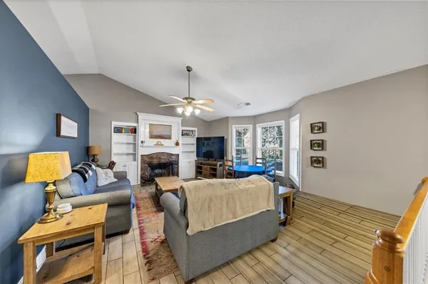 a living room with furniture and a wooden floor