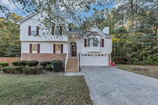 a house that has a tree in front of the house