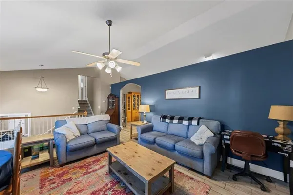 a kitchen with a refrigerator a stove a sink dishwasher and wooden cabinets with wooden floor