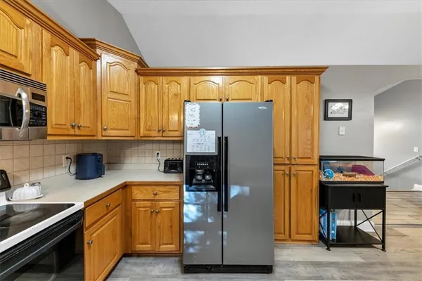 a view of a room with wooden floor and windows
