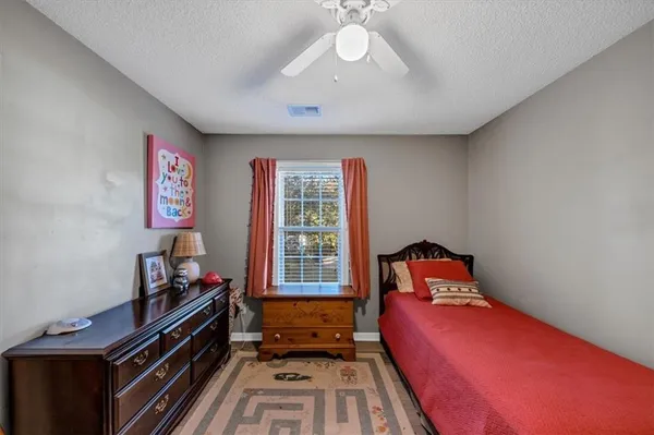 a bedroom with a bed couch and a window