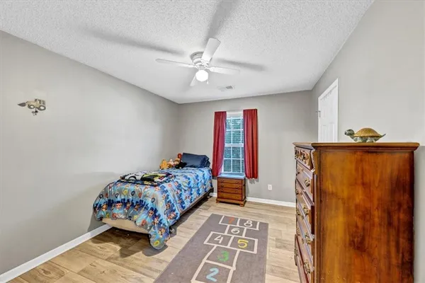 a bedroom with a bed and dresser