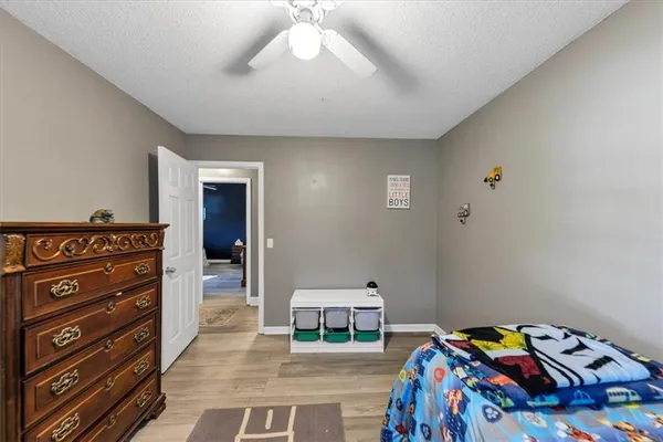 a bathroom with a sink a toilet a mirror and shower