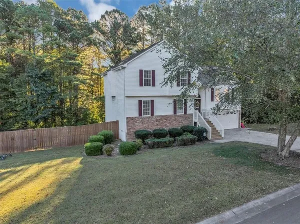 a front view of a house with garden