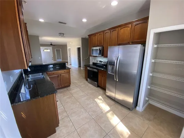 a kitchen with stainless steel appliances a refrigerator and a stove top oven