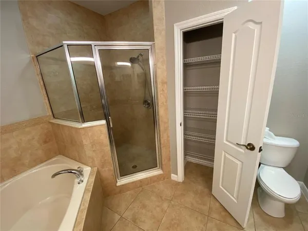 a bathroom with a tub and a toilet