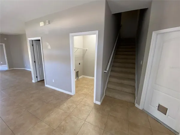 a view of entryway with wooden floor and stairs