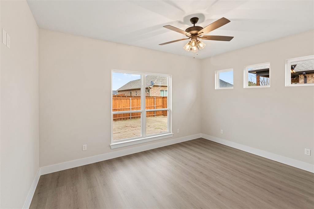 506 Limestone Circle Mabank, TX 75147 - Photo 19 of 33 wooden floor in an empty room with a window