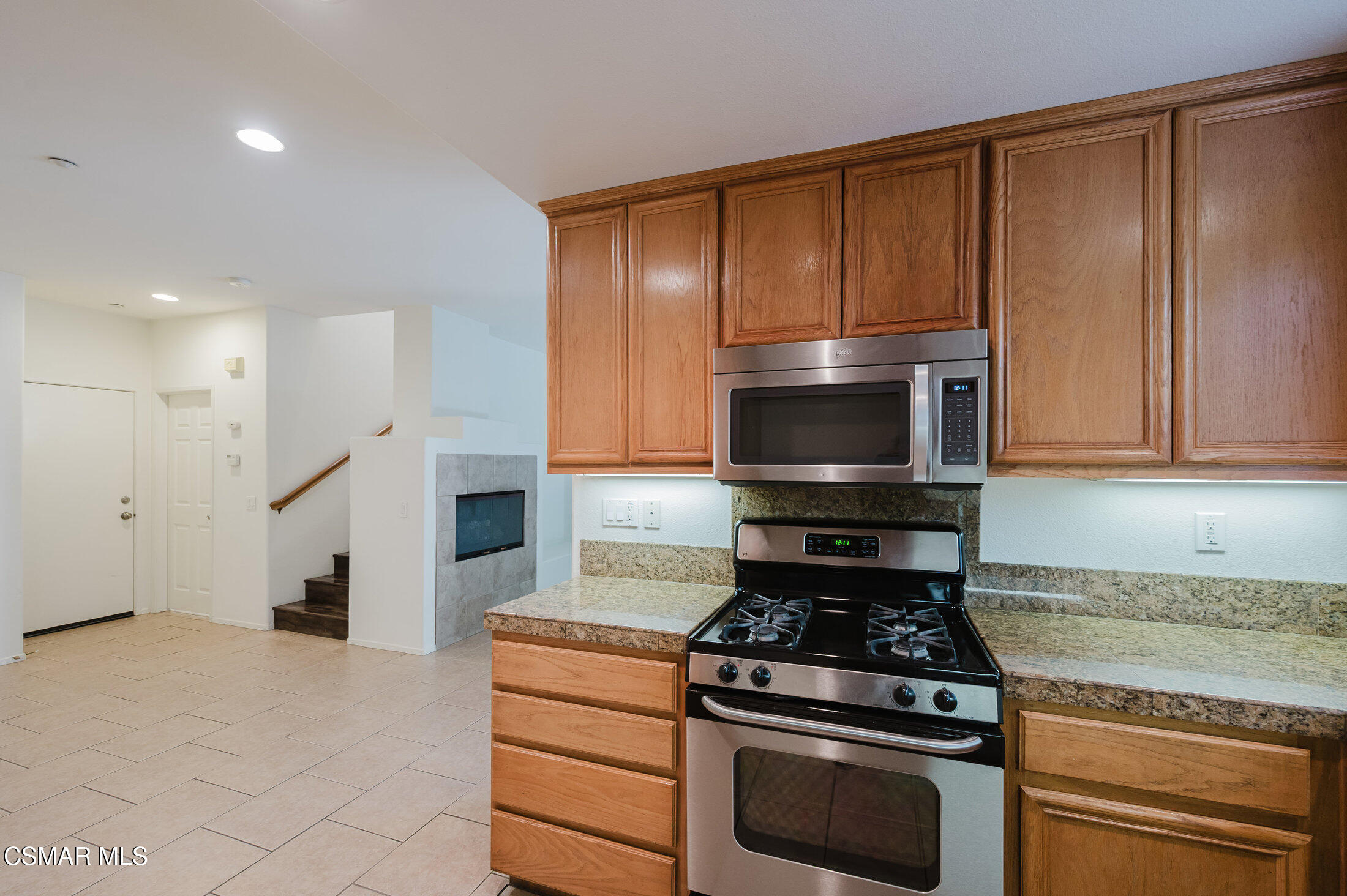 1454 Patricia Avenue, Unit 402 Simi Valley, CA 93065 - Photo 21 of 50 a kitchen with granite countertop wooden cabinets and stainless steel appliances