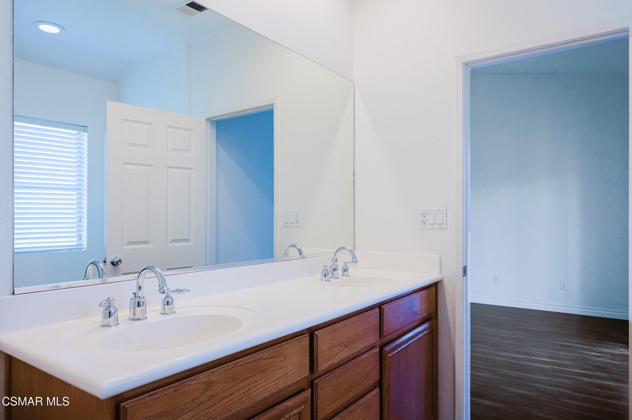 1454 Patricia Avenue, Unit 402 Simi Valley, CA 93065 - Photo 31 of 50 a bathroom with a sink and a mirror