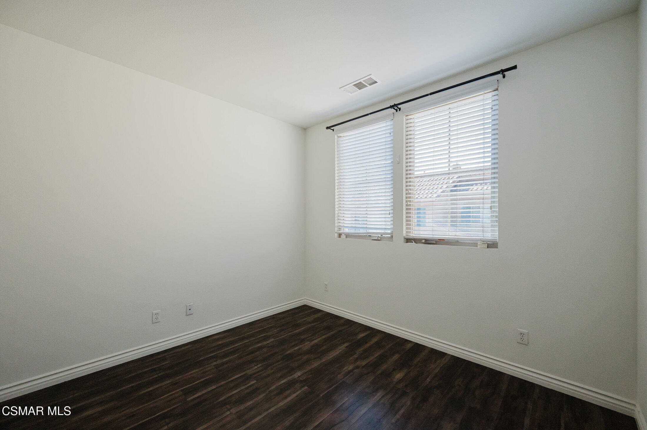1454 Patricia Avenue, Unit 402 Simi Valley, CA 93065 - Photo 36 of 50 an empty room with wooden floor and windows