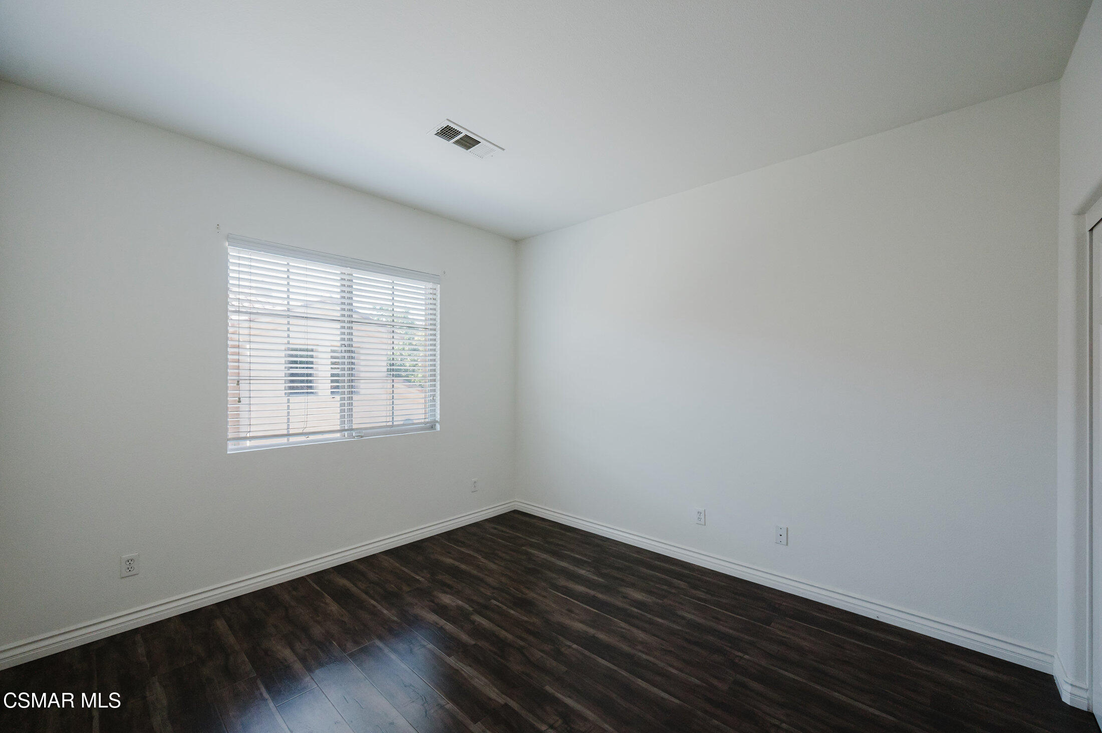 1454 Patricia Avenue, Unit 402 Simi Valley, CA 93065 - Photo 40 of 50 an empty room with wooden floor and windows