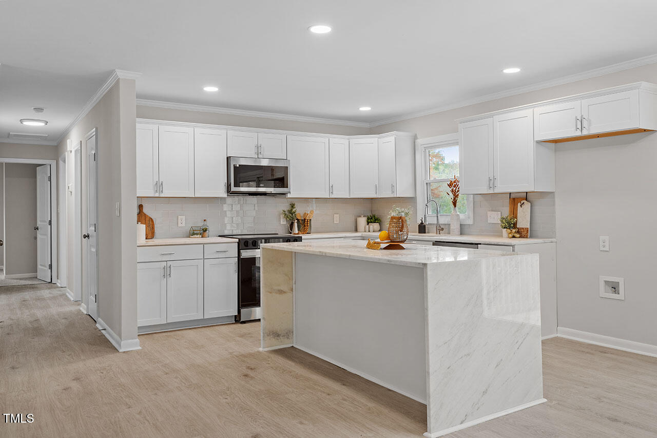 3904 Ingram Drive Raleigh, NC 27604 - Photo 2 of 37 a kitchen with sink cabinets and stainless steel appliances