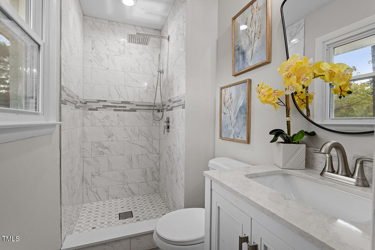 3904 Ingram Drive Raleigh, NC 27604 - Photo 27 of 37 a bathroom with a sink toilet and shower