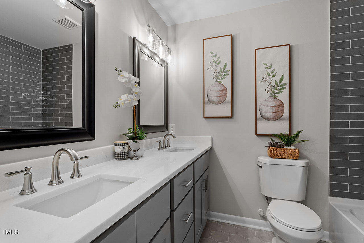 3904 Ingram Drive Raleigh, NC 27604 - Photo 8 of 37 a bathroom with a toilet sink and mirror