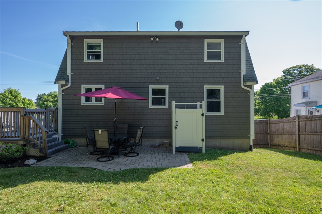 29 Wituwamat Road Weymouth, MA 02191 - Photo 35 of 42 a backyard of a house with table and chairs