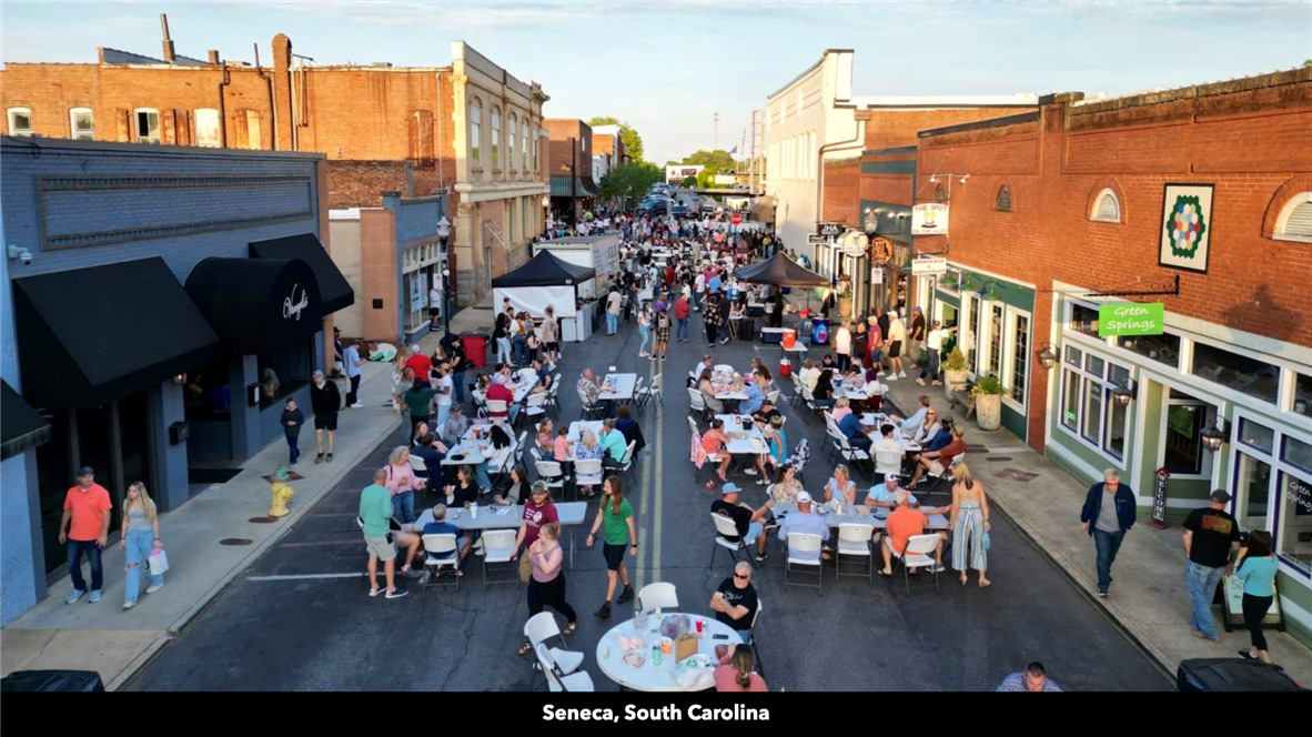 26 Wilbanks Road Seneca, SC 29678 - Photo 27 of 47 This vibrant street scene captures a lively outdoor gathering, offering a glimpse into local community life.